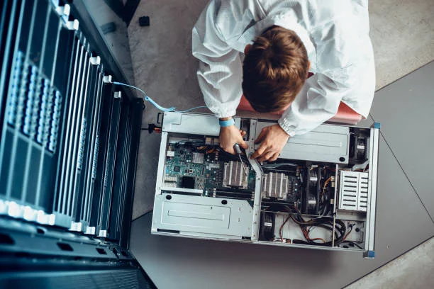 IT Engineer Servicing Part of a Supercomputer. IT Engineer Servicing Part of a Supercomputer.