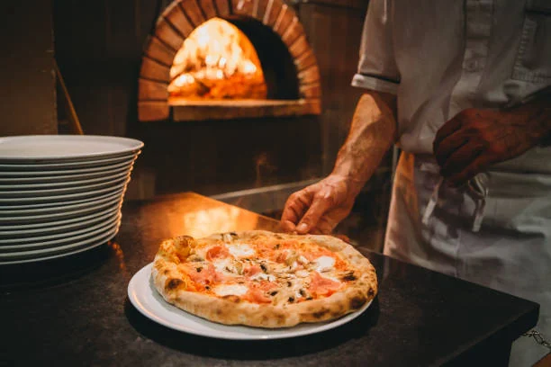 Pizza chef preparing pizza at the restaurant Pizza chef preparing pizza at the restaurant