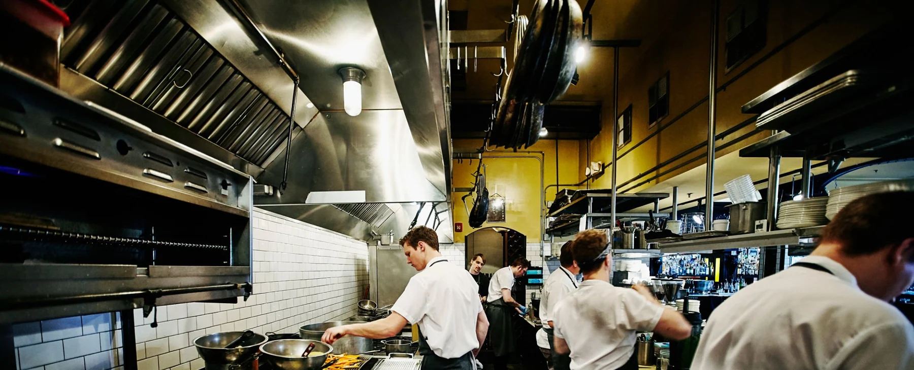 Chef and kitchen staff preparing dinner in restaurant kitchen Chef and kitchen staff preparing dinner in restaurant kitchen